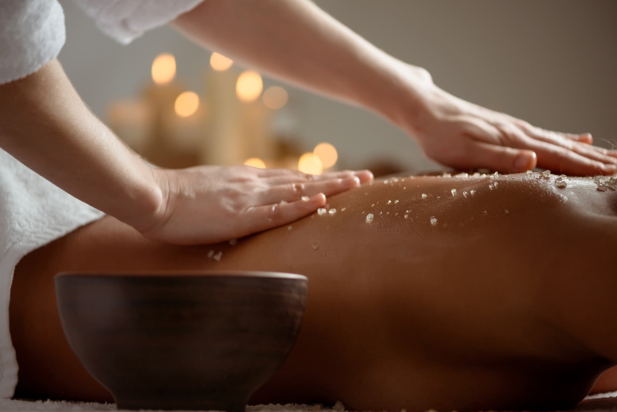 Serene salt-scrub treatment ritual by candlelight at Isa Spa